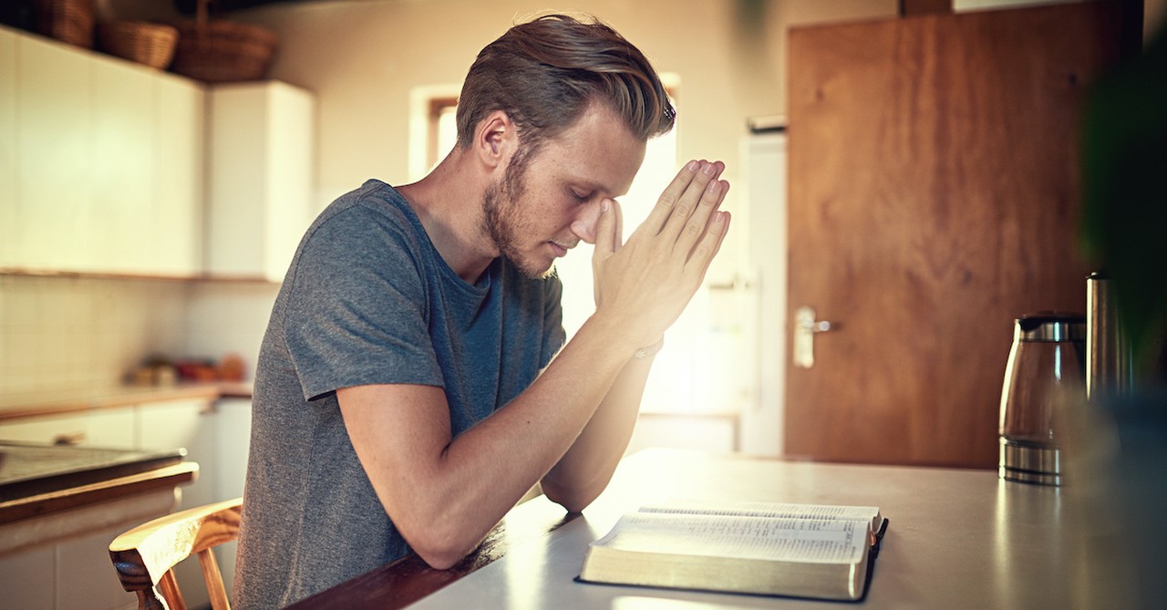 man praying over open Bible on table in the morning, judge not that you be judged meaning