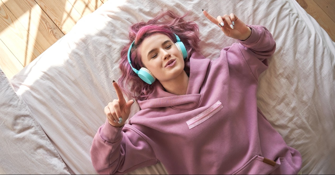 Young woman listening to music on her headphones