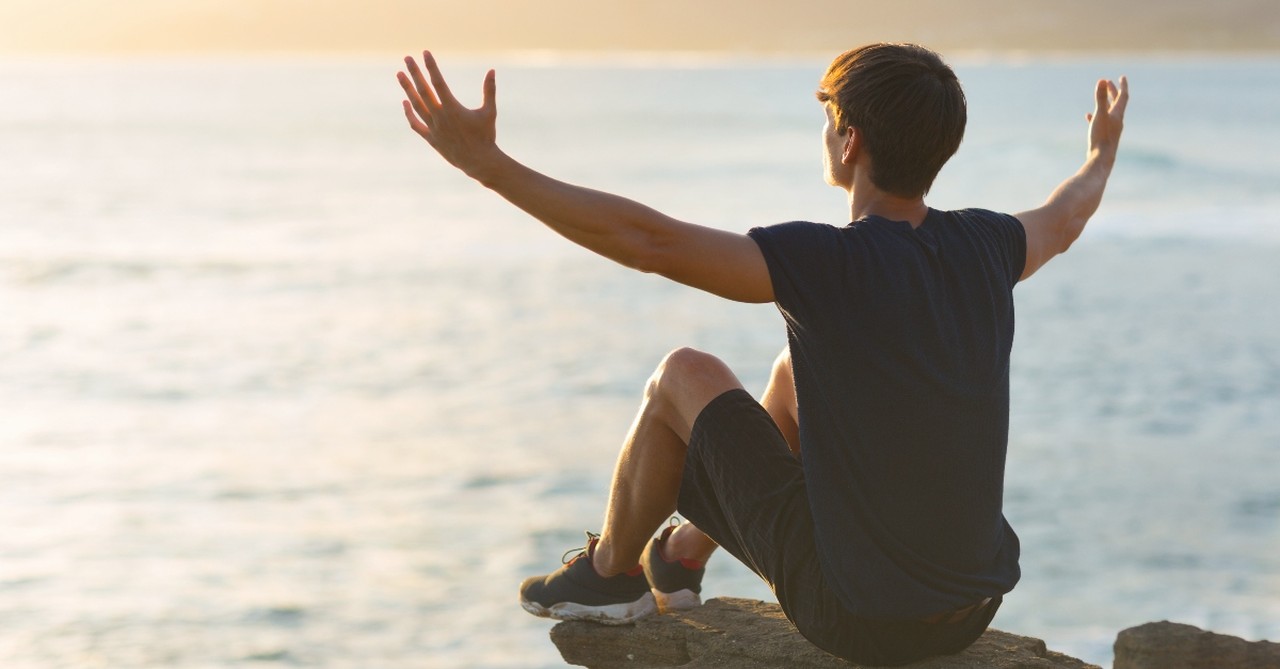 Man stretching out his arms in prayer
