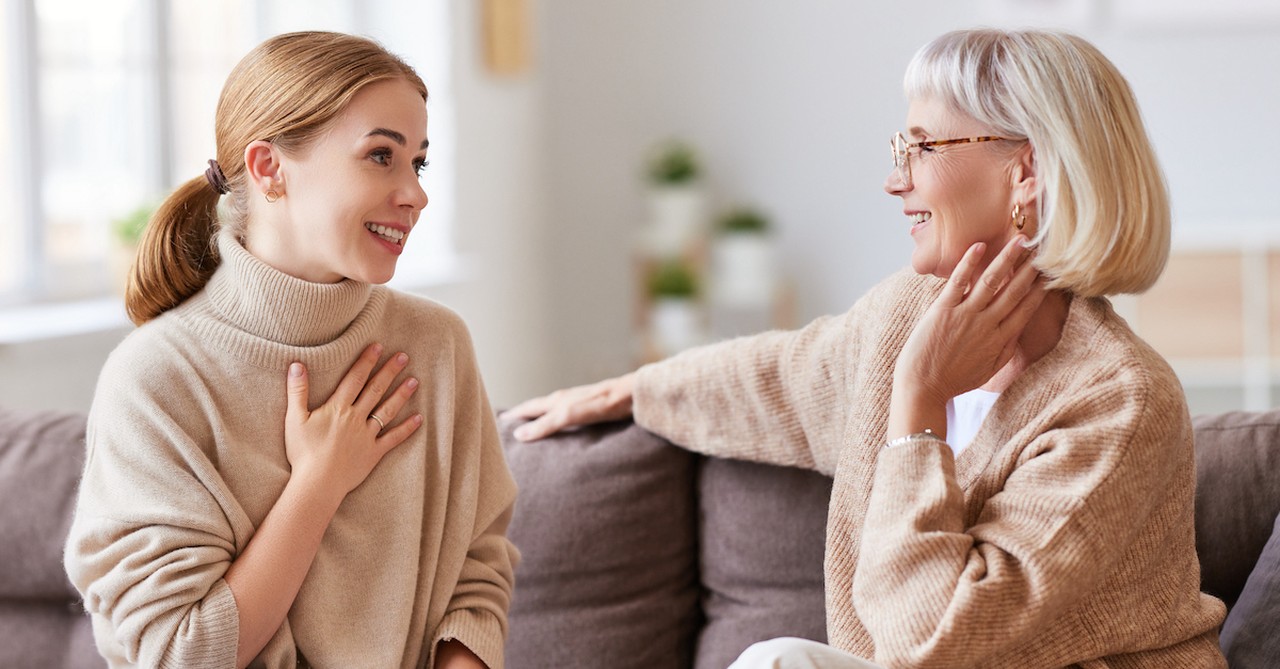 A young woman talking with an older woman