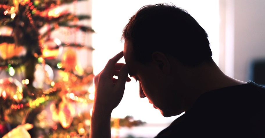 depressed man next to christmas tree, theodicy