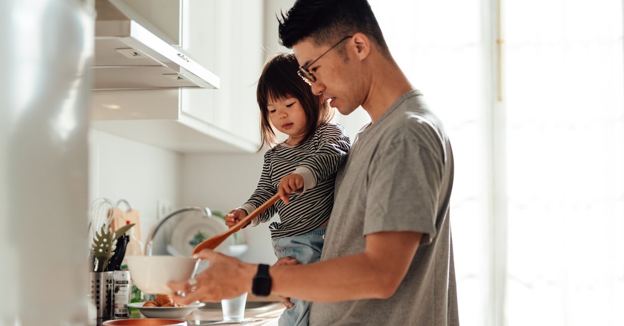 Dad cooking in kitchen with daughter