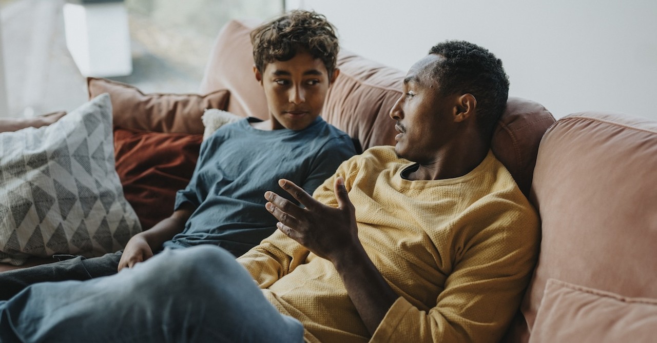 Dad father and son on couch serious talk discipline