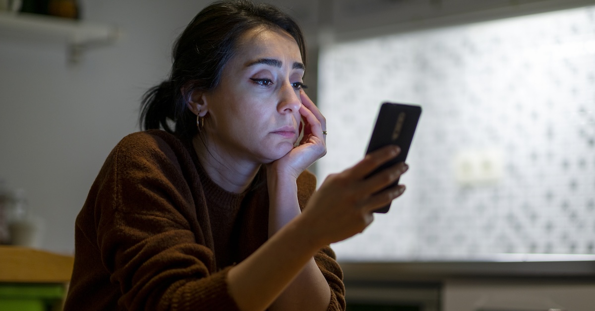 Woman on phone social media posting cellphone stressed overwhelmed