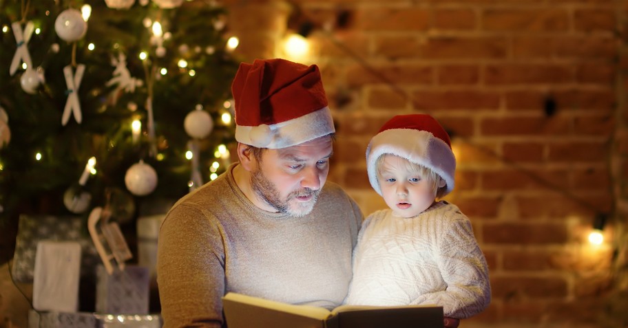 dad and baby wearing santa hats with christmas tree; christmas peace prayer