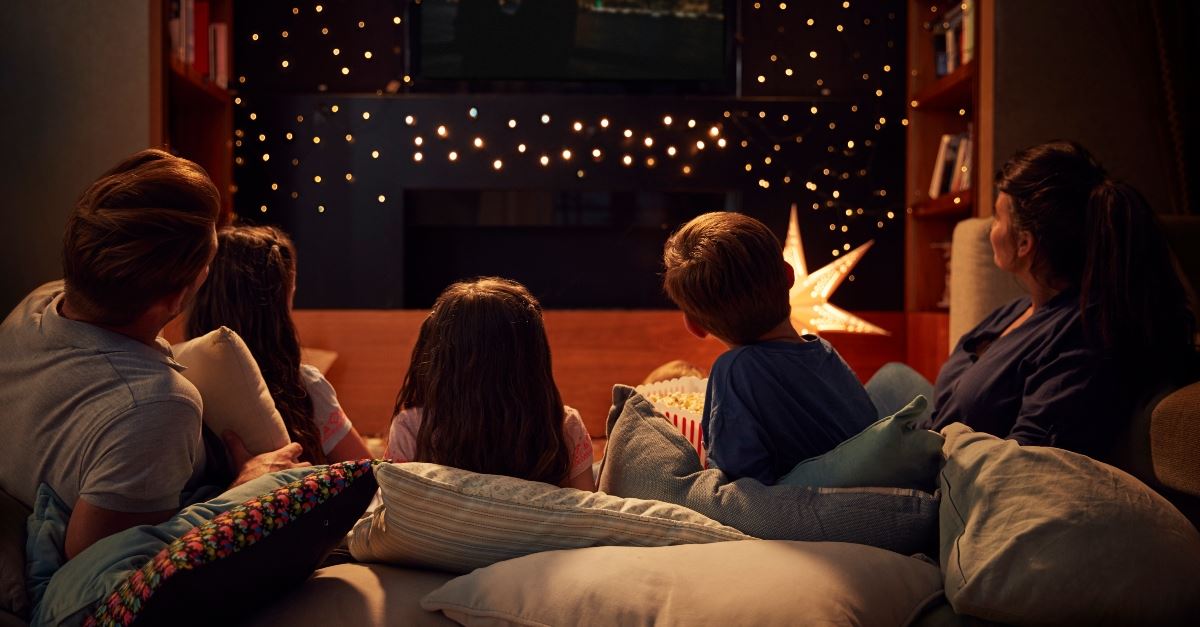 family watching movie together at night