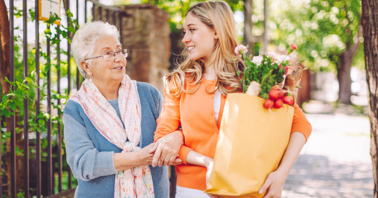 Younger woman humbly helping an elderly woman carry her groceries home; quotes about love
